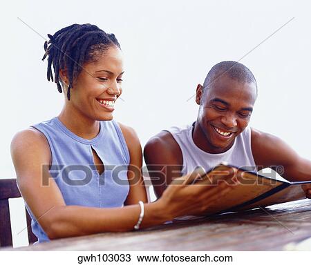 Close-up of a young couple holding a notepad and looking down, Bermuda View Large Photo Image Stock Image - Close-up of a young couple holding a notepad and looking down, Bermuda. Fotosearch