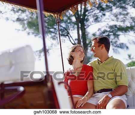 Close-up of a young couple sitting and looking at each other, Bermuda View Large Photo Image Stock Photo - Close-up of a young couple sitting and looking at each other, Bermuda. Fotosearch
