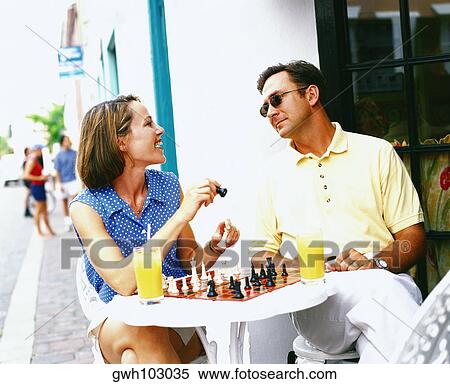 Close-up of a young couple sitting on chairs and looking at each other, Bermuda View Large Photo Image Stock Photography - Close-up of a young couple sitting on chairs and looking at each other, Bermuda. Fotosearch