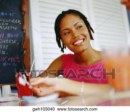 Stock Image - Close-up of a young woman looking sideways and smiling, Bermuda. Fotosearch