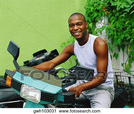 Portrait of a young man riding a scooter, Bermuda View Large Photo Image Stock Image - Portrait of a young man riding a scooter, Bermuda. Fotosearch