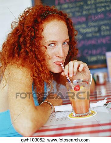 Portrait of a young woman drinking juice with the help of a drinking straw, Bermuda View Large Photo Image Stock Image - Portrait of a young woman drinking juice with the help of a drinking straw, Bermuda. Fotosearch