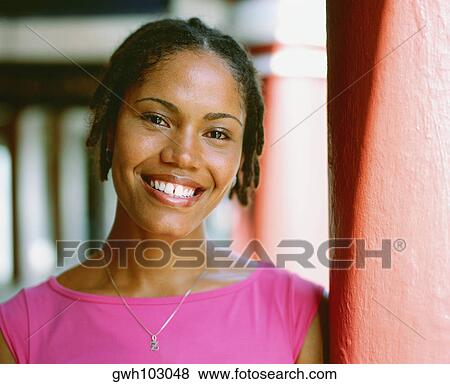 Stock Photo - Portrait of a young woman leaning against a column, Bermuda. Fotosearch