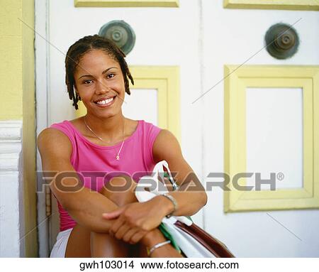 Portrait of a young woman sitting and hugging her knees, Bermuda View Large Photo Image Picture - Portrait of a young woman sitting and hugging her knees, Bermuda. Fotosearch