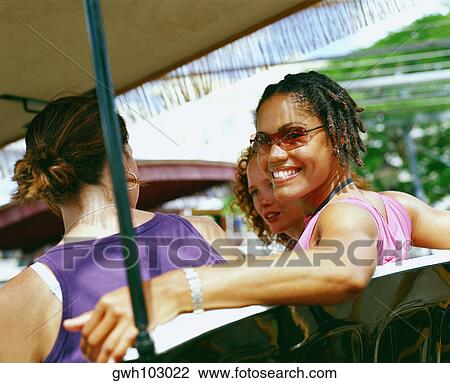 Stock Image - Portrait of a young woman smiling, Bermuda. Fotosearch