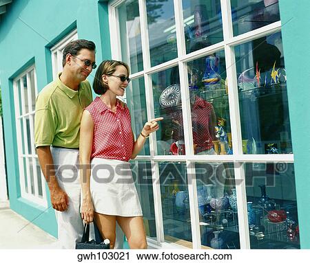 Young couple standing in front of a display window and looking at decorative urn, Bermuda View Large Photo Image Stock Image - Young couple standing in front of a display window and looking at decorative urn, Bermuda. Fotosearch