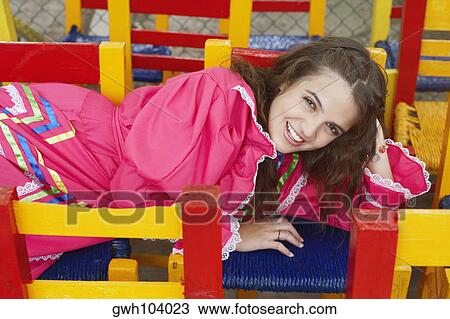 High angle view of a young woman lying on chairs View Large Photo Image Stock Image - High angle view of a young woman lying on chairs. Fotosearch