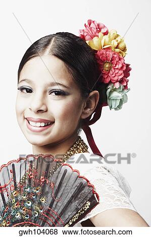 Stock Photo - Portrait of a girl holding a folding fan and smiling. Fotosearch