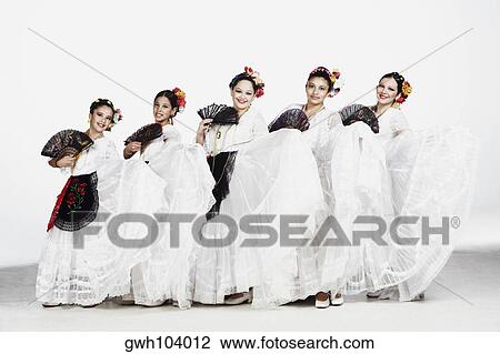 Stock Image - Portrait of a group of female dancers holding folding fans. Fotosearch