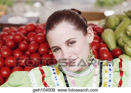 Portrait of a young woman at a market stall View Large Photo Image Stock Photo - Portrait of a young woman at a market stall. Fotosearch