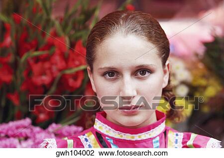 Portrait of a young woman in front of a flower shop View Large Photo Image Stock Image - Portrait of a young woman in front of a flower shop. Fotosearch