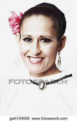 Portrait of a young woman posing and smiling View Large Photo Image Stock Photograph - Portrait of a young woman posing and smiling. Fotosearch
