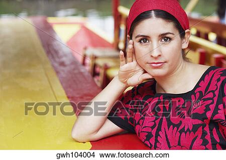 Portrait of a young woman with her hand on her head View Large Photo Image Picture - Portrait of a young woman with her hand on her head. Fotosearch
