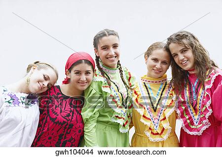 Portrait of five young women standing with their arms around each other and smiling View Large Photo Image Picture - Portrait of five young women standing with their arms around each other and smiling. Fotosearch