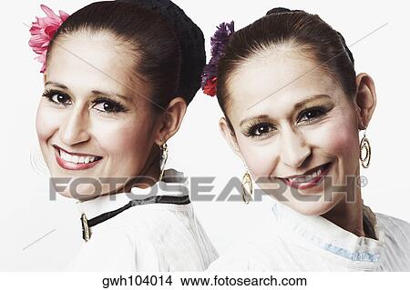 Picture - Portrait of two young women posing and smiling. Fotosearch