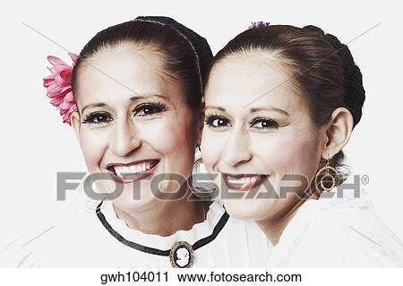 Portrait of two young women posing and smiling View Large Photo Image Stock Image - Portrait of two young women posing and smiling. Fotosearch