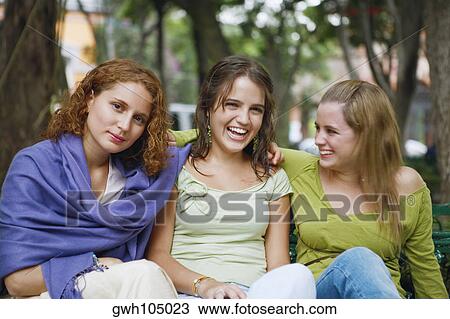 Close-up of three young women sitting together View Large Photo Image Stock Image - Close-up of three young women sitting together. Fotosearch