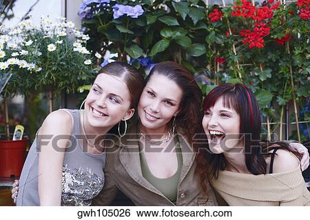 Close-up of three young women smiling View Large Photo Image Stock Photograph - Close-up of three young women smiling. Fotosearch
