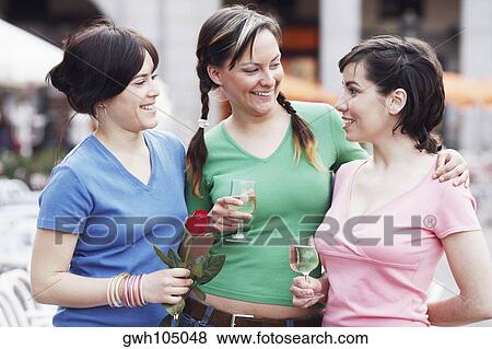 Close-up of three young women standing together View Large Photo Image Stock Photo - Close-up of three young women standing together . Fotosearch