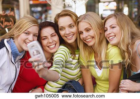 Five young women taking a photograph of themselves View Large Photo Image Stock Photography - Five young women taking a photograph of themselves . Fotosearch