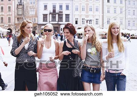 Group of young women walking with ice-cream cones View Large Photo Image Stock Image - Group of young women walking with ice-cream cones . Fotosearch