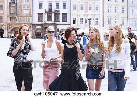 Stock Photo - Group of young women walking with ice-cream cones . Fotosearch