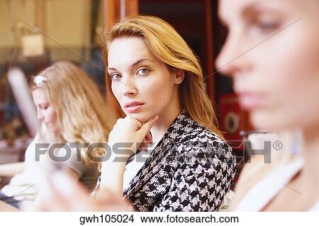 Portrait of a young woman with her hand on her chin View Large Photo Image Picture - Portrait of a young woman with her hand on her chin . Fotosearch