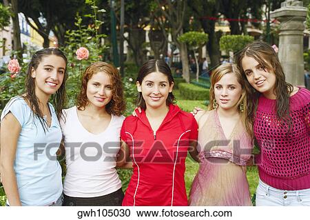 Stock Image - Portrait of five young women in a garden. Fotosearch