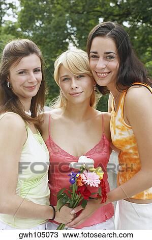 Portrait of three young women smiling View Large Photo Image Stock Image - Portrait of three young women smiling . Fotosearch