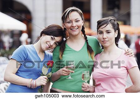 Portrait of three young women standing together View Large Photo Image Stock Image - Portrait of three young women standing together . Fotosearch