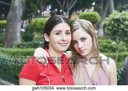 Portrait of two young women smiling View Large Photo Image Picture - Portrait of two young women smiling. Fotosearch