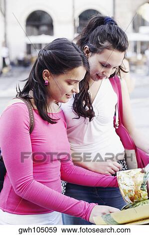Two young women shopping View Large Photo Image Stock Photo - Two young women shopping . Fotosearch