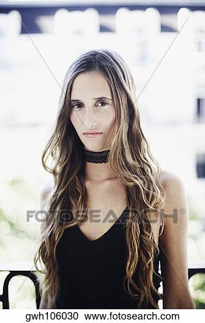 Stock Image - Portrait of a young woman looking serious. Fotosearch