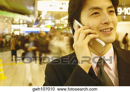 Close-up of a businessman talking on a mobile phone View Large Photo Image Stock Image - Close-up of a businessman talking on a mobile phone . Fotosearch