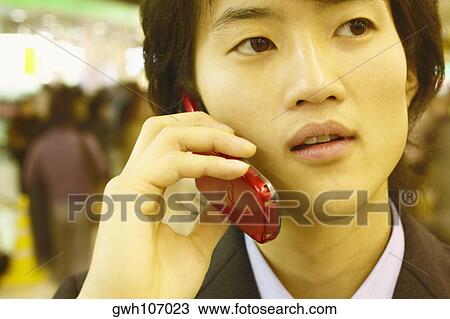 Stock Image - Close-up of a businessman talking on a mobile phone . Fotosearch