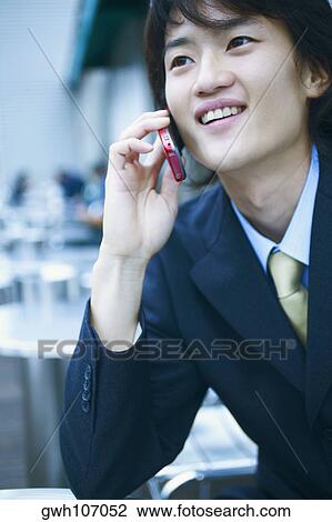 Close-up of a businessman talking on a mobile phone View Large Photo Image Stock Image - Close-up of a businessman talking on a mobile phone . Fotosearch