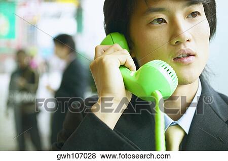 Close-up of a businessman talking on a mobile phone View Large Photo Image Stock Photo - Close-up of a businessman talking on a mobile phone. Fotosearch