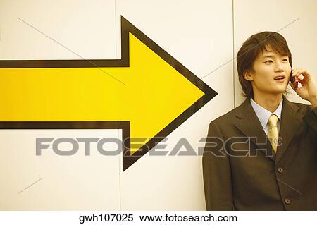 Close-up of a businessman talking on a mobile phone View Large Photo Image Stock Photography - Close-up of a businessman talking on a mobile phone. Fotosearch