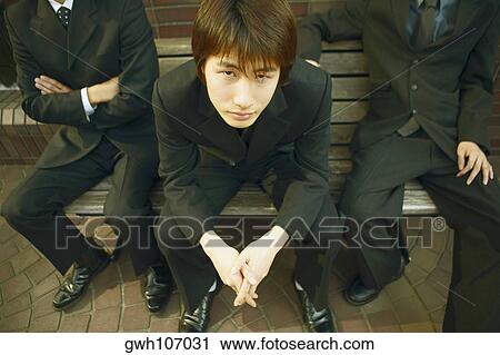 High angle view of a young man sitting on a bench View Large Photo Image Stock Image - High angle view of a young man sitting on a bench . Fotosearch