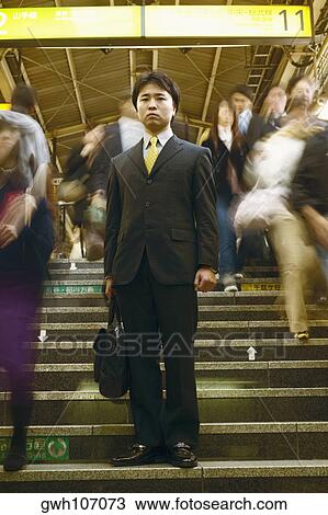 Low angle view of a businessman standing on steps View Large Photo Image Stock Image - Low angle view of a businessman standing on steps . Fotosearch