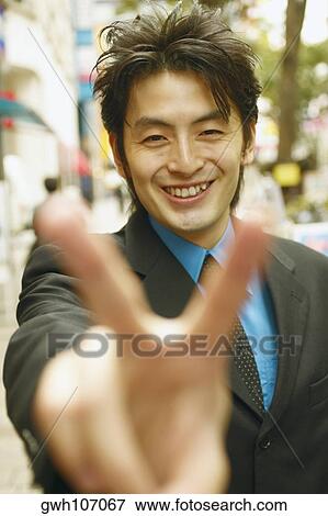 Portrait of a businessman making the peace sign View Large Photo Image Stock Photo - Portrait of a businessman making the peace sign . Fotosearch