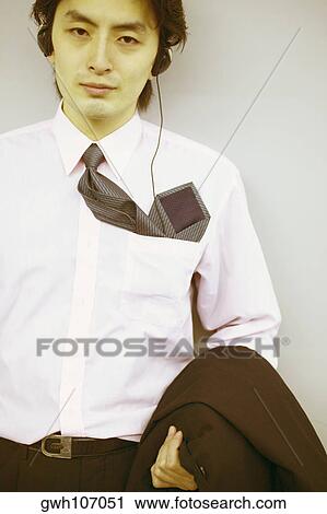 Portrait of a businessman wearing headphones View Large Photo Image Stock Image - Portrait of a businessman wearing headphones. Fotosearch