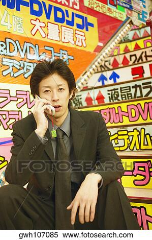 Portrait of a young man talking on a mobile phone View Large Photo Image Stock Photography - Portrait of a young man talking on a mobile phone . Fotosearch