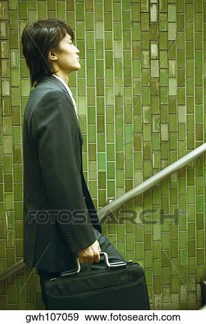 Side profile of a businessman walking up stairs View Large Photo Image Stock Photo - Side profile of a businessman walking up stairs. Fotosearch