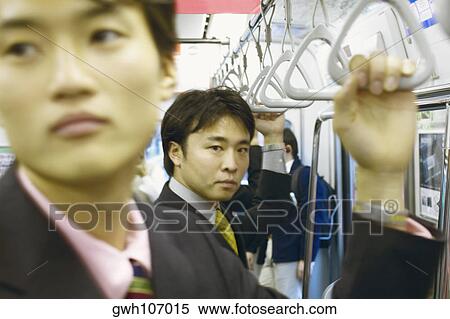 Stock Photography - Two businessmen traveling in a train . Fotosearch
