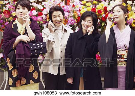 Four women talking on mobile phones View Large Photo Image Stock Image - Four women talking on mobile phones . Fotosearch