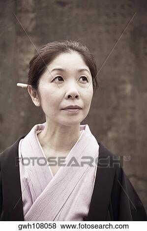 Mature woman looking up View Large Photo Image Stock Photo - Mature woman looking up . Fotosearch
