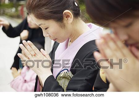 Stock Photograph - Mature woman praying . Fotosearch