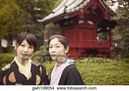 Picture - Portrait of a mature woman and her daughter in a garden . Fotosearch