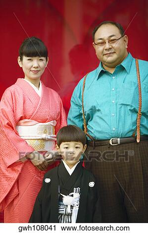 Portrait of a mid adult woman and a mature man with their child View Large Photo Image Stock Image - Portrait of a mid adult woman and a mature man with their child. Fotosearch